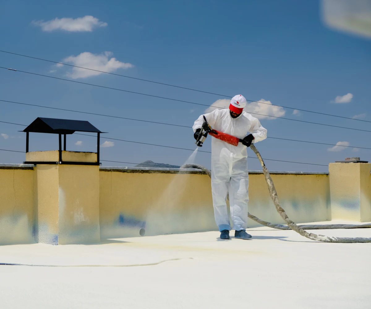 Waterproofing being spray-applied to a terrace surface